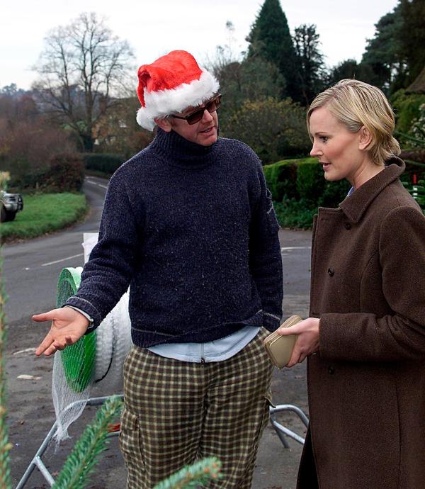 01/12/2001 -Ever wondered what Chris Evans has been doing since being sacked by Virgin.  We can exclusively reveal that he has set up shop to sell Christmas trees outside his local public house in Hascombe Chris is hoping to raise £10,000.  The trees start at £25. with Chris is Ceri Drewett, of Godalming, one happy customer