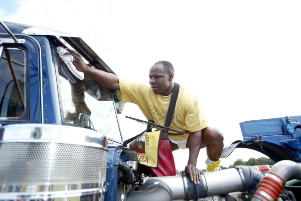 From PAUL BURGMAN-Press-Photos.com 12/06/04  - Chris Eubanks one of the Gumball participants polishes his Peterbilt Truck. The Gumball 3000 Polo Reunion Party  - (PIC PAUL BURGMAN) Contact Press-Photos.com on 07866694105