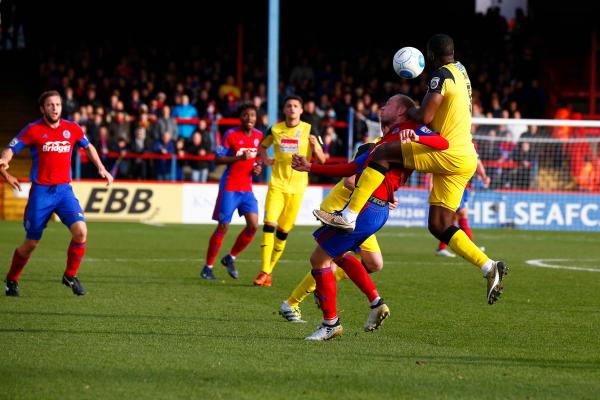 26/12/2016.  Aldershot Town v Woking FC. Scott RENDELL battles